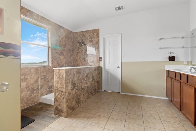 bathroom with visible vents, a walk in shower, vanity, vaulted ceiling, and tile patterned flooring