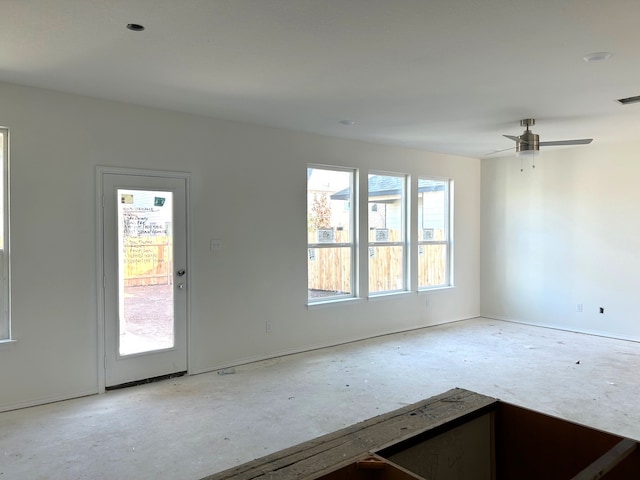 unfurnished room featuring ceiling fan and plenty of natural light