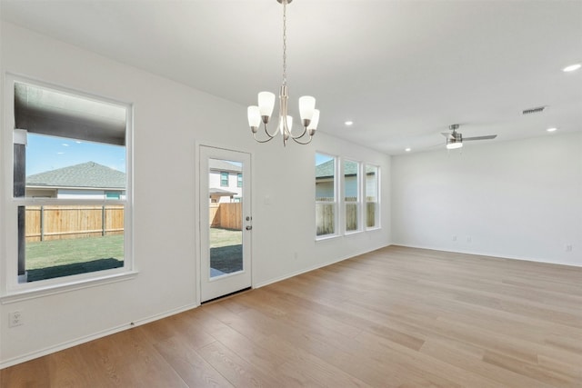14013 Vigilance St, Manor, TX 78653 - empty room featuring light wood-style floors, a chandelier, a ceiling fan, and recessed lighting
