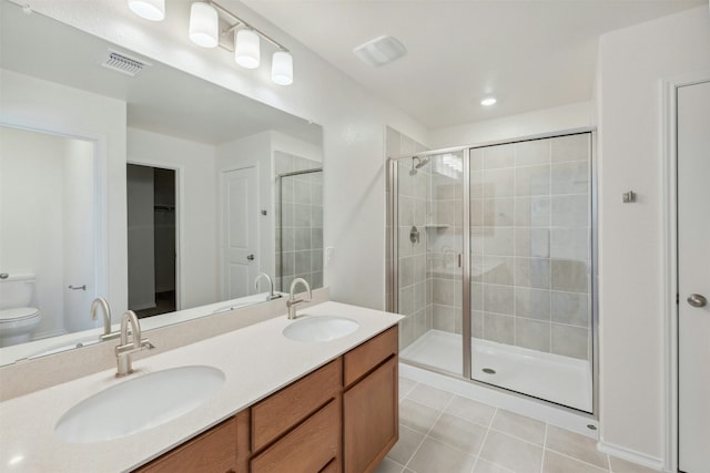 14013 Vigilance St, Manor, TX 78653 - full bath featuring a shower stall, tile patterned floors, double vanity, and a walk in closet