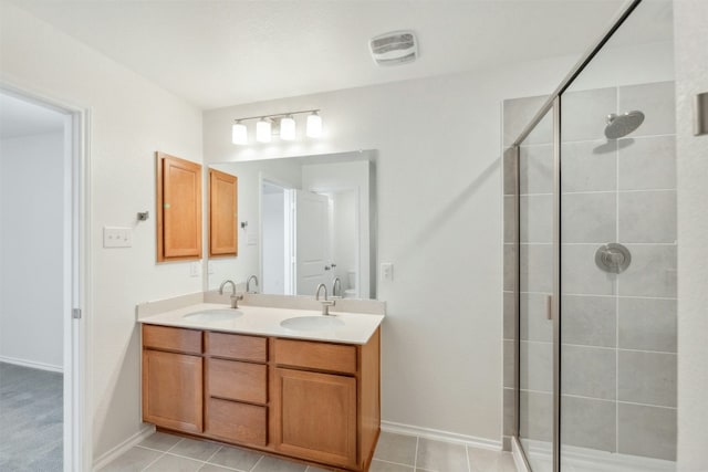 14013 Vigilance St, Manor, TX 78653 - bathroom with a stall shower, double vanity, and tile patterned flooring