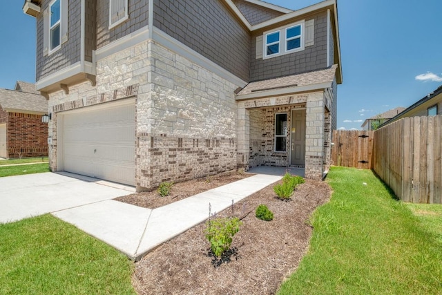 14013 Vigilance St, Manor, TX 78653 - view of front of home with a garage, stone siding, and driveway