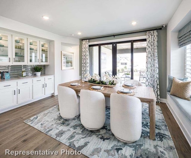 dining room with a healthy amount of sunlight and dark hardwood / wood-style floors