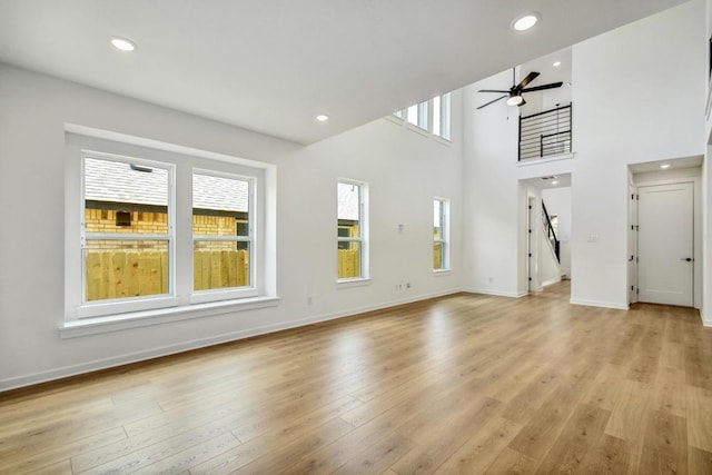 unfurnished living room with light wood-style floors, recessed lighting, baseboards, and ceiling fan