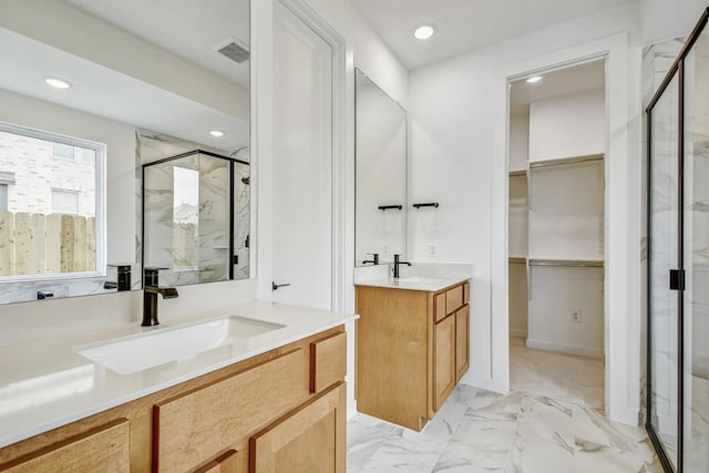 full bath with recessed lighting, a sink, a marble finish shower, and a walk in closet