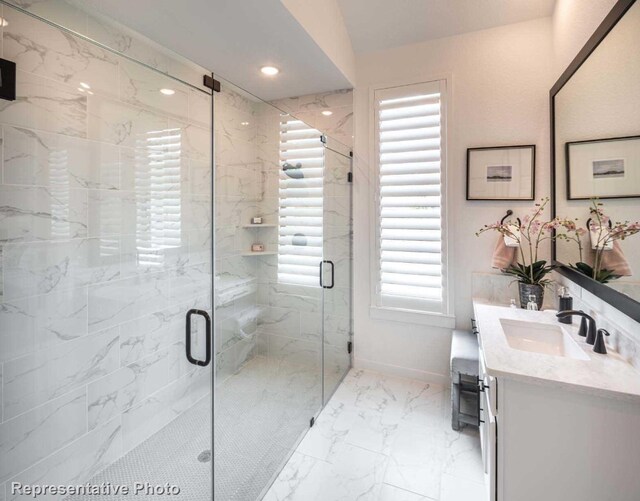 bathroom with lofted ceiling, vanity, an enclosed shower, and a healthy amount of sunlight