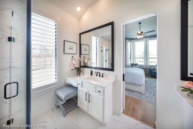 bathroom featuring walk in shower, vanity, ceiling fan, and lofted ceiling