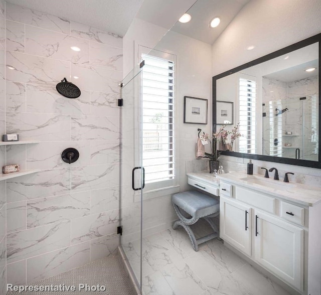 bathroom with vanity and a shower with door