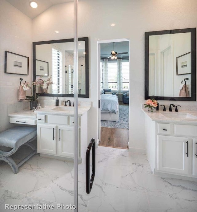 bathroom featuring ceiling fan, vanity, and vaulted ceiling