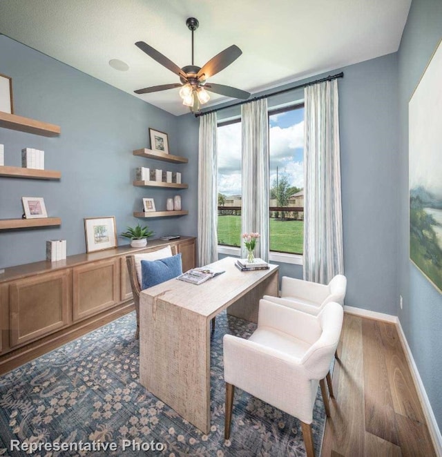 office area with dark hardwood / wood-style flooring and ceiling fan