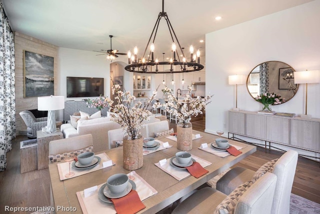 dining space with ceiling fan, dark hardwood / wood-style floors, and sink