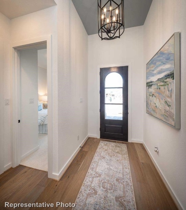 entrance foyer featuring hardwood / wood-style floors and an inviting chandelier