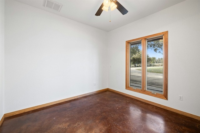 unfurnished room featuring ceiling fan and concrete floors