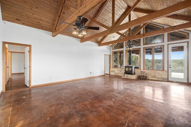 unfurnished living room featuring beamed ceiling, a wood stove, high vaulted ceiling, and wooden ceiling