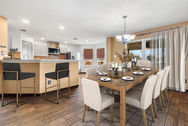 dining space with an inviting chandelier