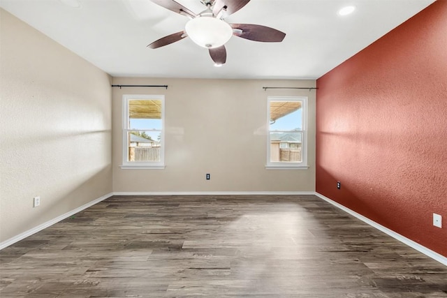 empty room featuring dark hardwood / wood-style flooring and ceiling fan