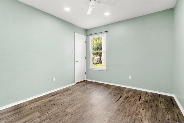 empty room featuring ceiling fan and dark wood-type flooring