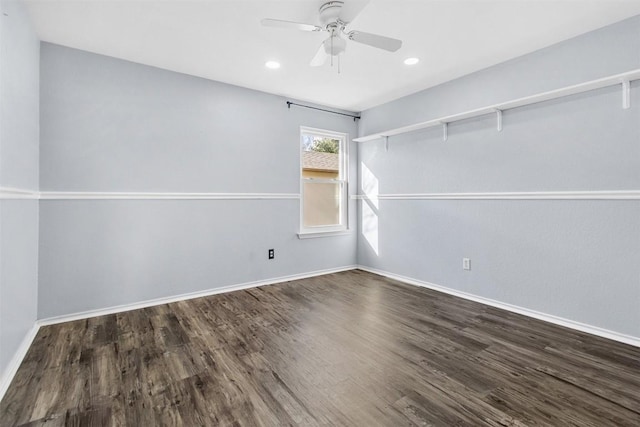 empty room with ceiling fan and dark hardwood / wood-style flooring