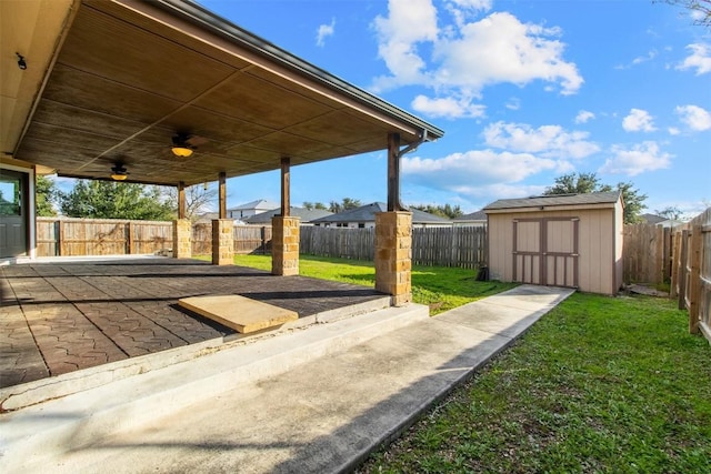 view of patio / terrace featuring ceiling fan and a storage shed