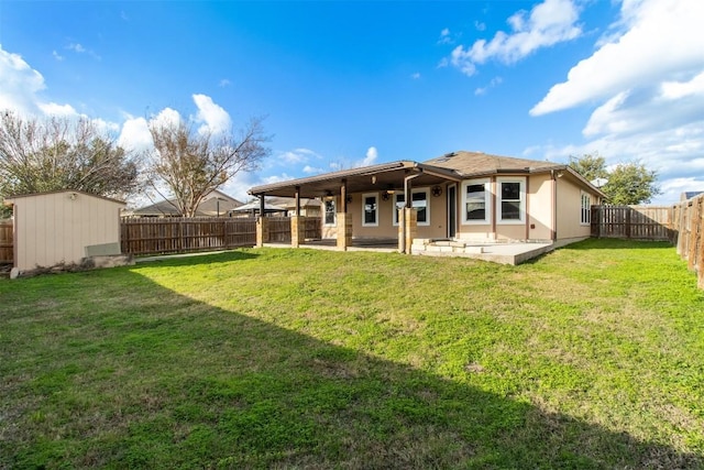 back of property featuring a lawn, a patio area, and a storage shed