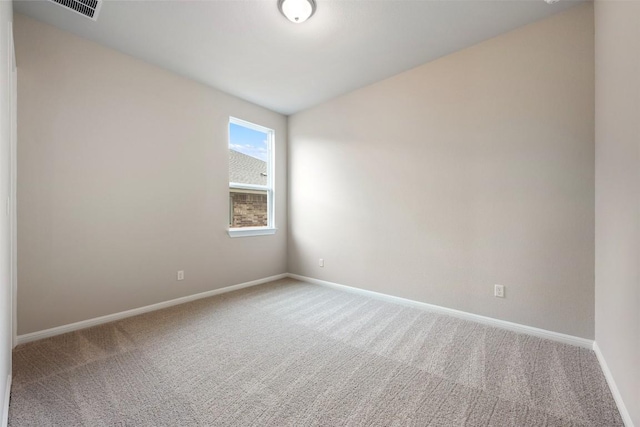 unfurnished room featuring carpet, visible vents, and baseboards