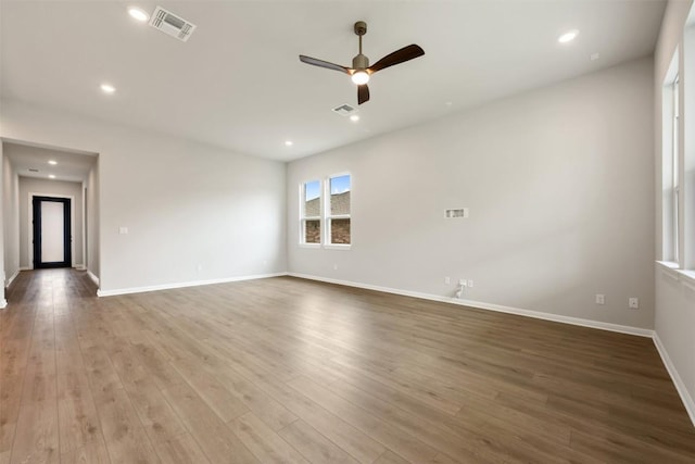 unfurnished room featuring wood finished floors, visible vents, recessed lighting, ceiling fan, and baseboards
