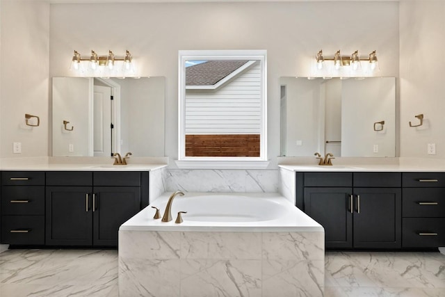 bathroom featuring a sink, two vanities, a garden tub, and marble finish floor