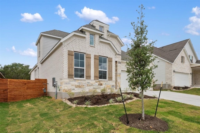 view of front of house with concrete driveway, a garage, a front lawn, and fence