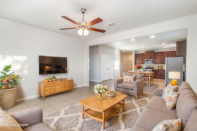 living room with ceiling fan and light tile patterned flooring