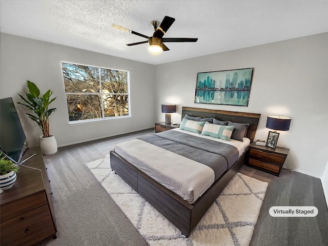 bedroom featuring ceiling fan, carpet floors, and a textured ceiling