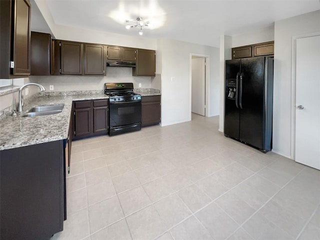 kitchen with black appliances, sink, light stone countertops, dark brown cabinets, and light tile patterned flooring