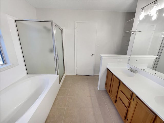 bathroom featuring tile patterned floors, separate shower and tub, and vanity