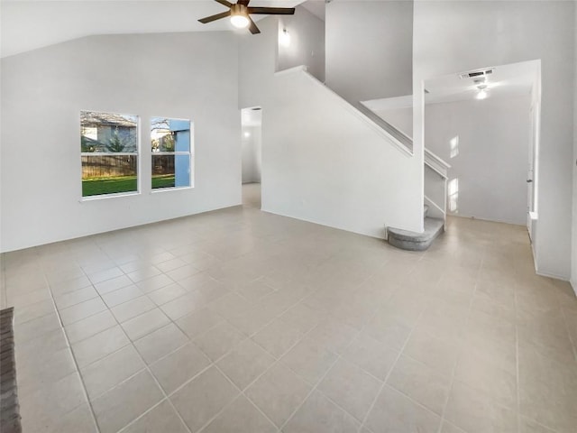 unfurnished living room featuring ceiling fan, light tile patterned floors, and high vaulted ceiling