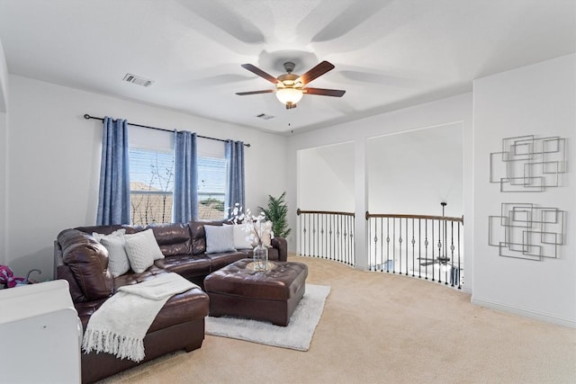 living room featuring light carpet and ceiling fan