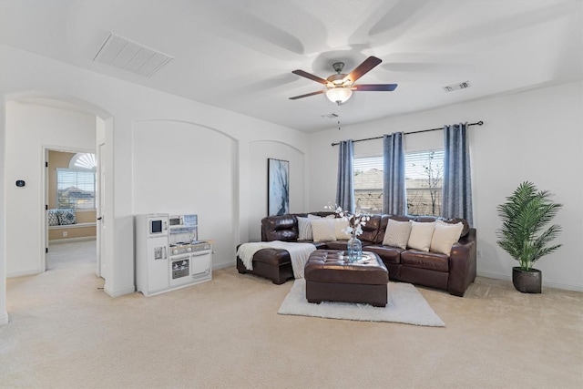 living room featuring light colored carpet and ceiling fan