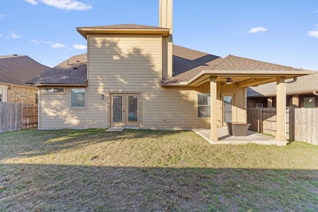 back of house with a yard, a patio, and french doors