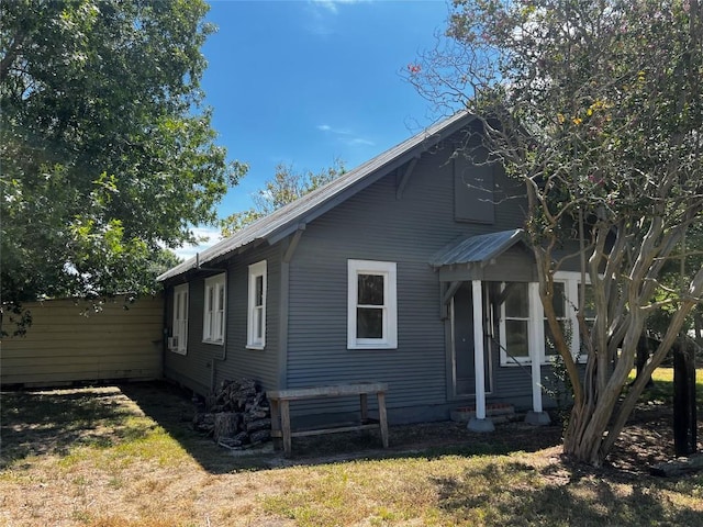 view of side of home with a yard