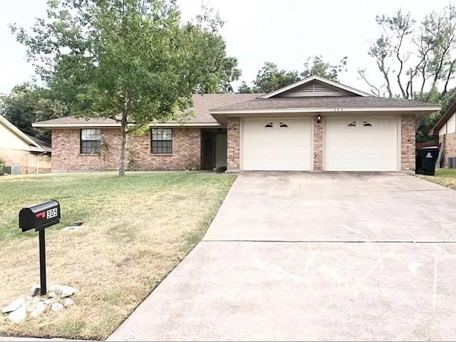 ranch-style home with a front yard and a garage