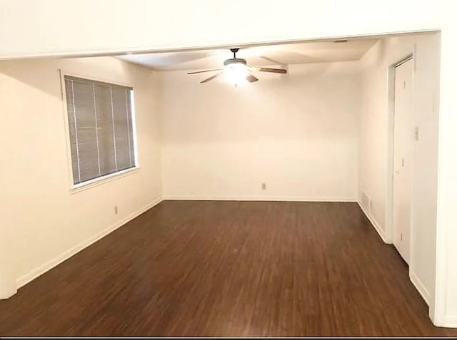 spare room with dark hardwood / wood-style flooring and ceiling fan