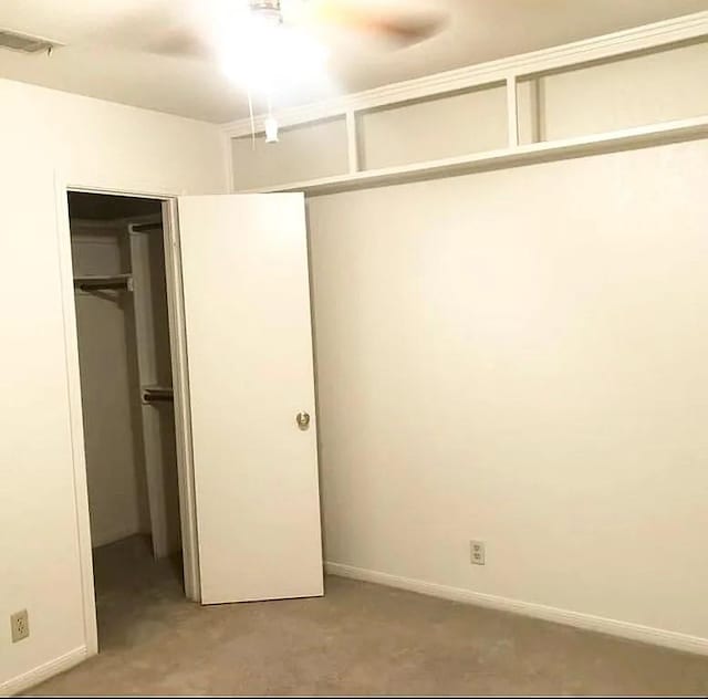 unfurnished bedroom with a closet and ceiling fan