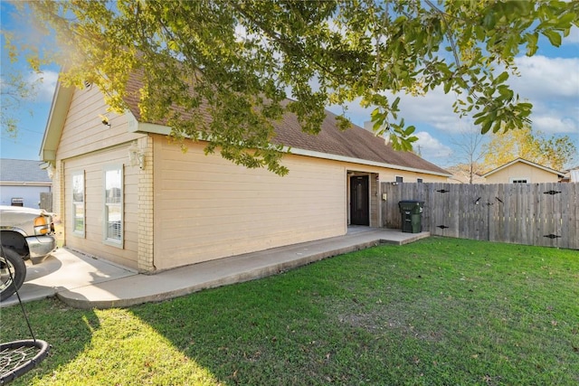 view of home's exterior featuring a yard and a patio