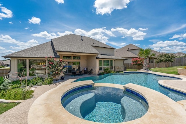 view of swimming pool with an in ground hot tub and a patio