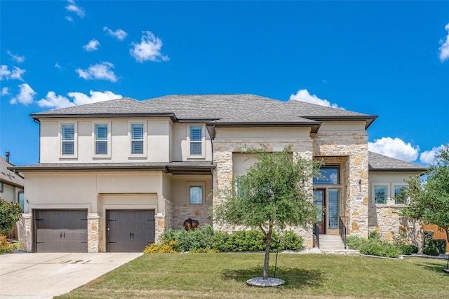 prairie-style home with a garage and a front lawn