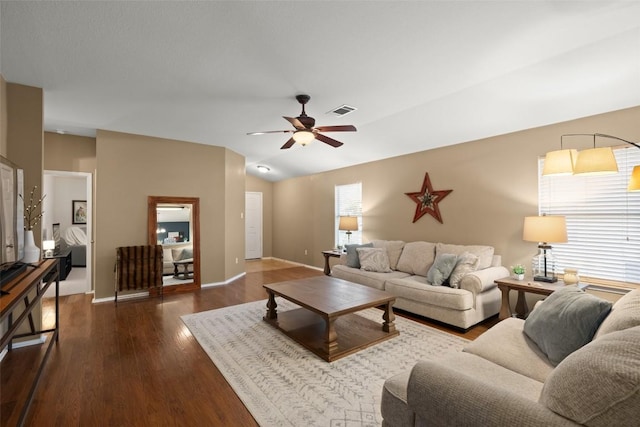 living room featuring dark hardwood / wood-style floors, vaulted ceiling, and ceiling fan