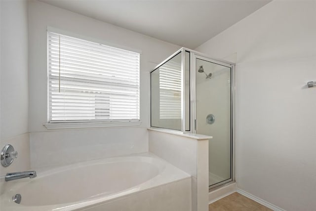 bathroom featuring plus walk in shower and tile patterned floors