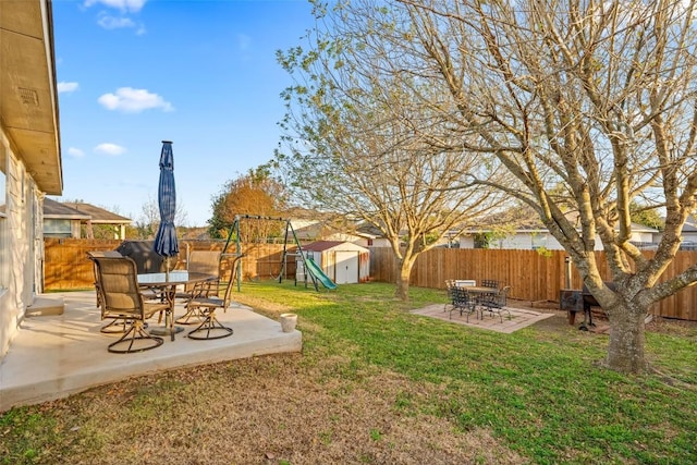 view of yard featuring a patio area and a shed