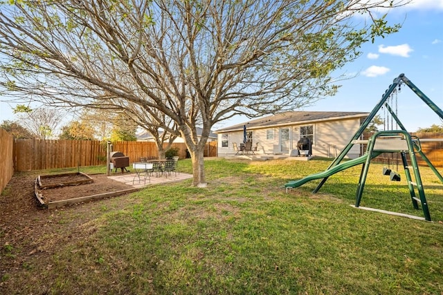 view of yard featuring a playground and a patio area