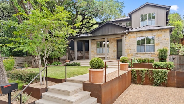 1005 Jewell St, Austin, TX 78704 - view of front of property with stone siding, board and batten siding, a standing seam roof, a metal roof, and covered porch