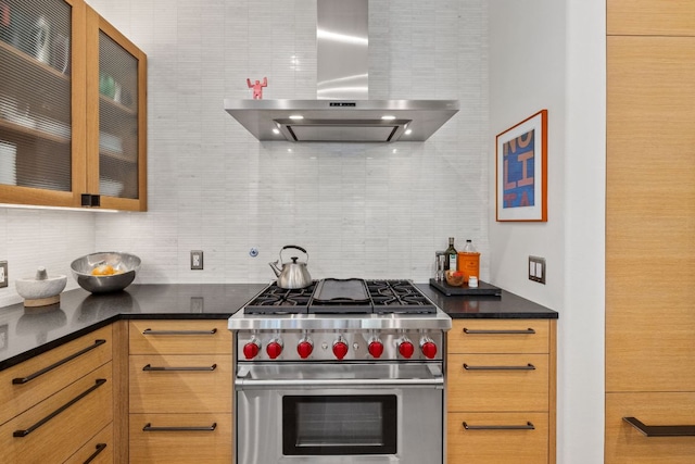 1005 Jewell St, Austin, TX 78704 - kitchen featuring premium range, wall chimney range hood, tasteful backsplash, and dark countertops