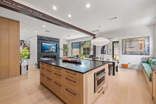 1005 Jewell St, Austin, TX 78704 - kitchen with modern cabinets, dark countertops, light wood-type flooring, open floor plan, and recessed lighting